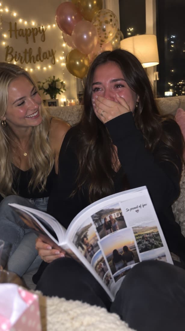 Her reaction: hand over her mouth, happy tears, the magazine open on her lap